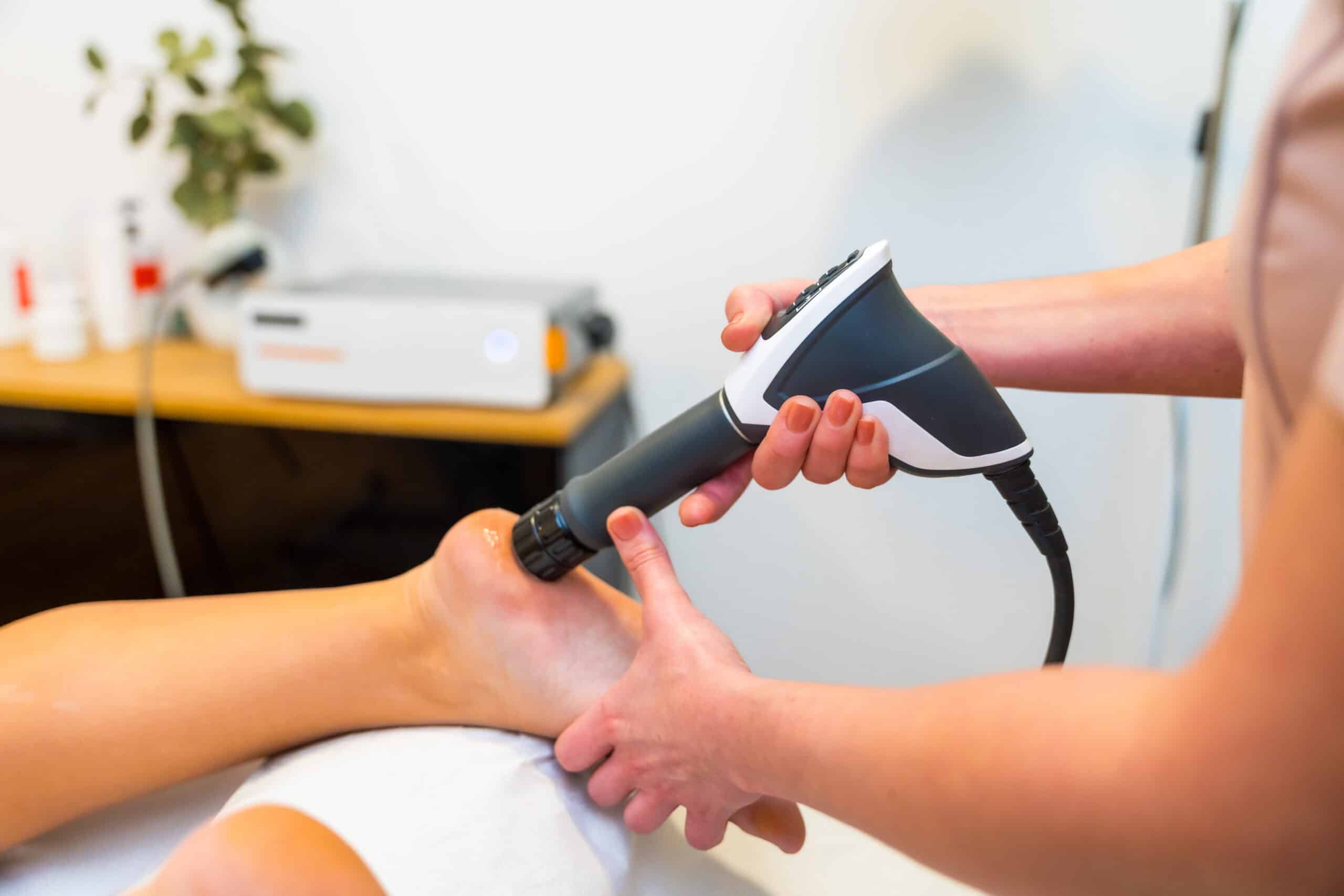 pressure wave device being used on a patient's foot